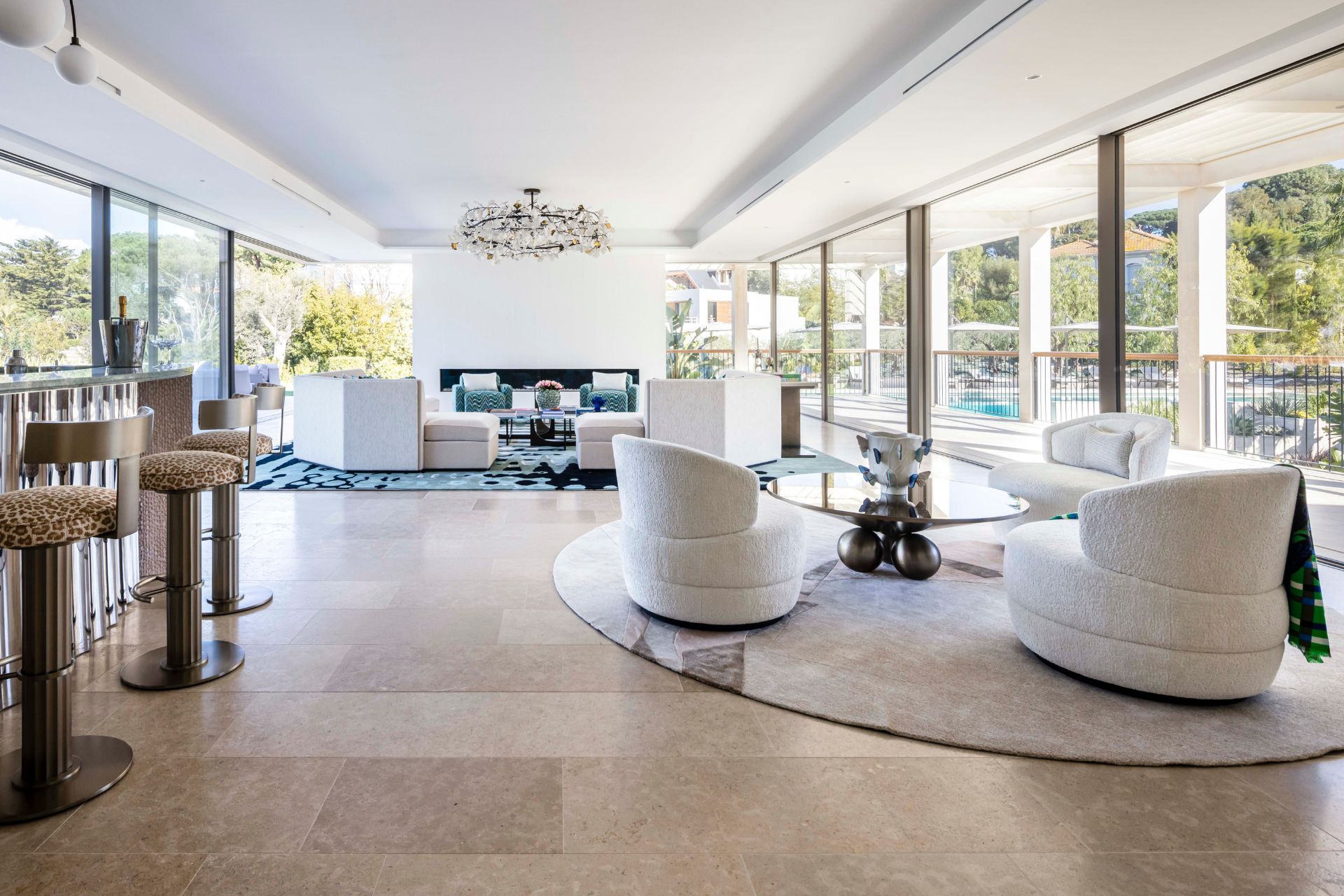 Living room with leopard print bar stool and cream sofas