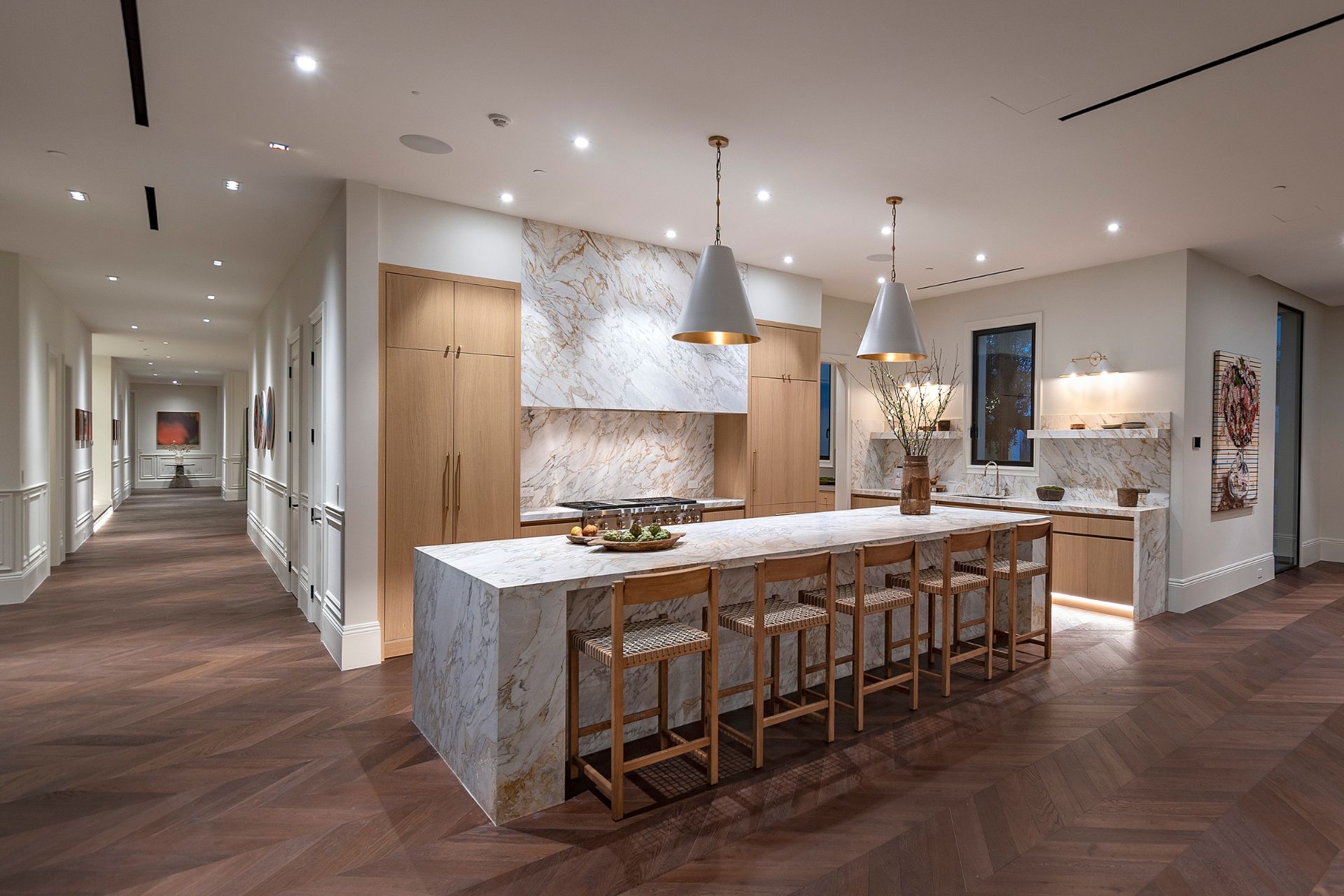 Kitchen with light wooden cabinets and marble countertops