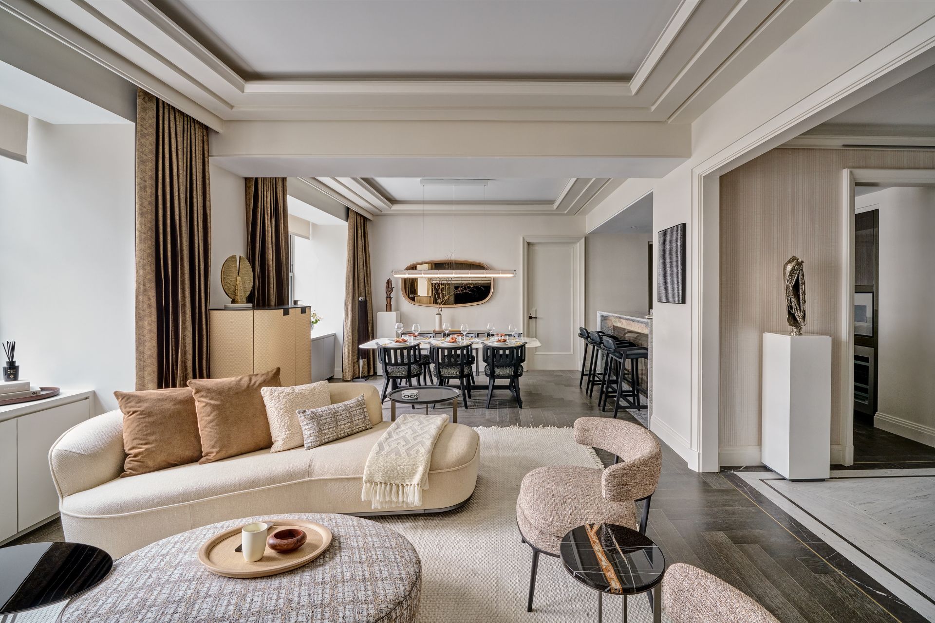 Cream living room with curved boucle sofas and a round coffee table.