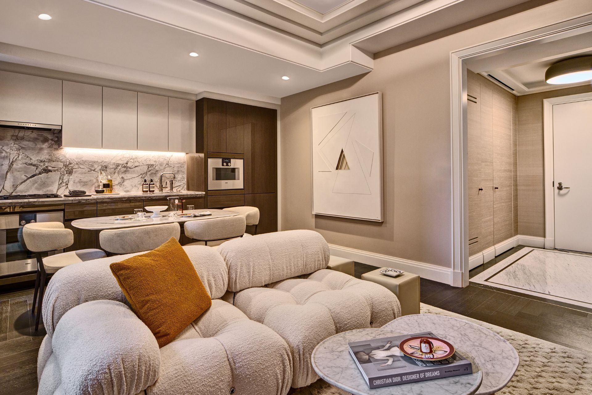 Living room with curved cream sofa and round coffee table