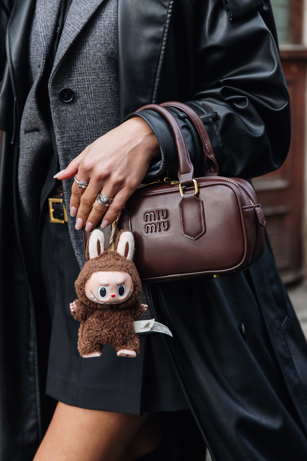 Close of handbag with Labubu doll